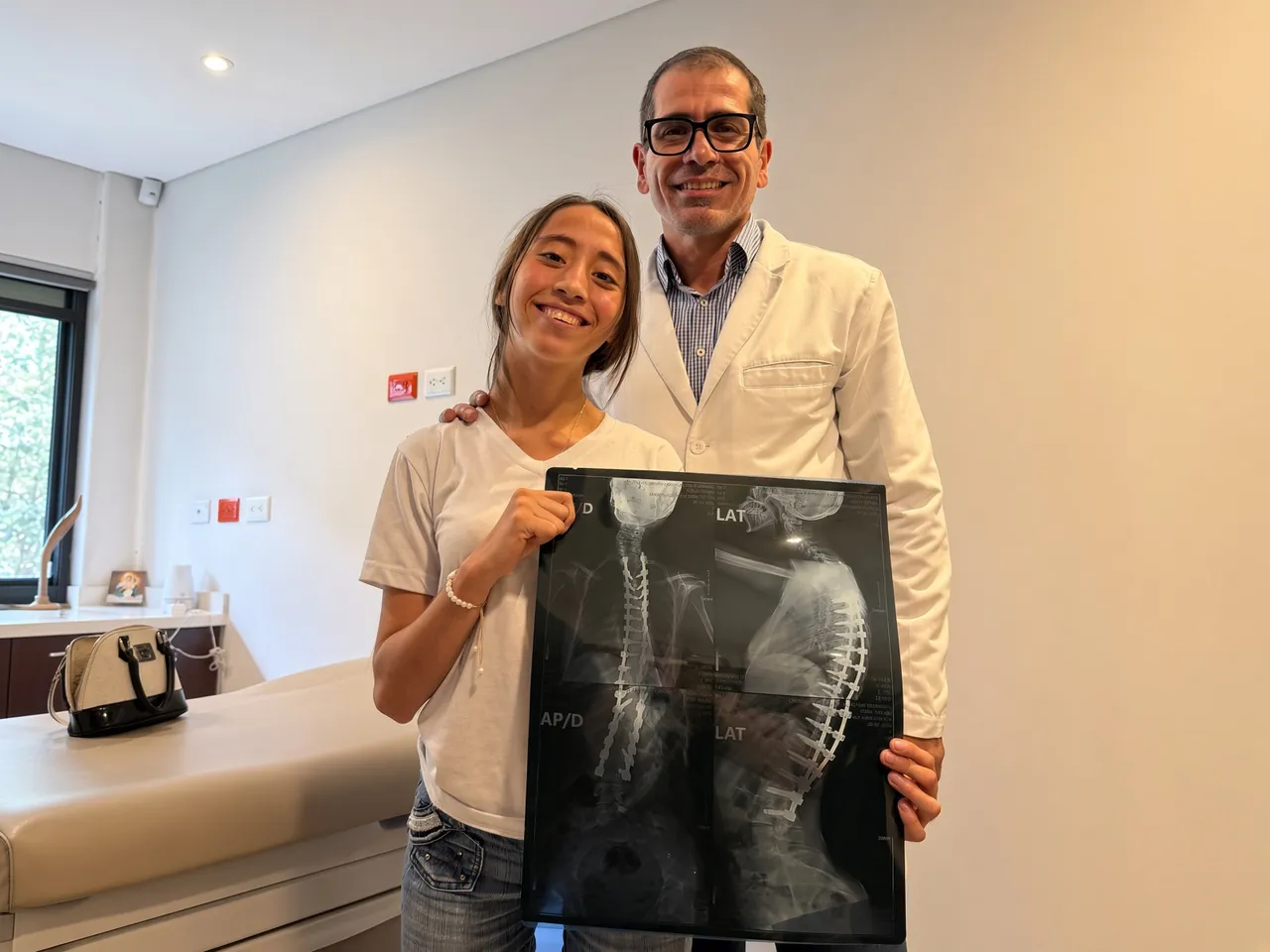 Ecuador surgeon standing with a smiling patient after recovery