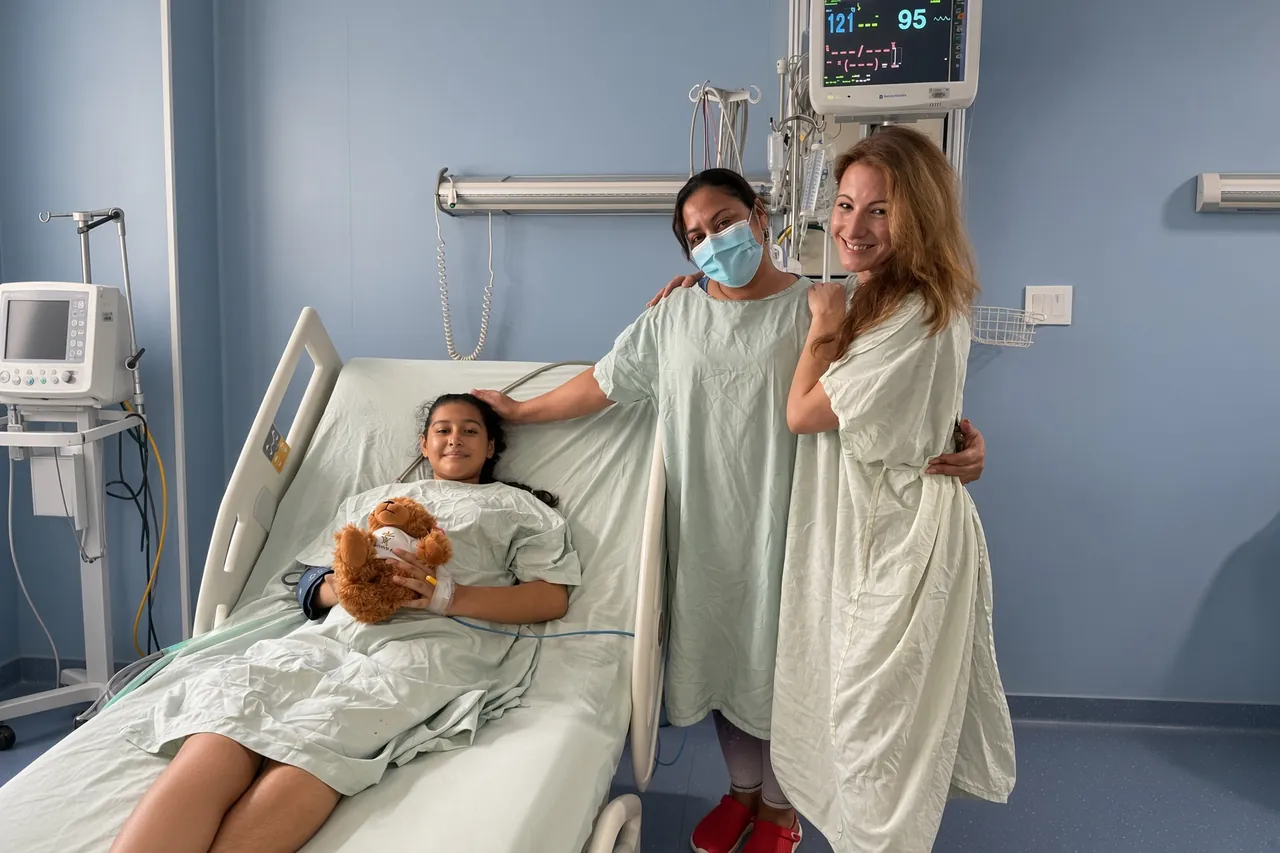 A SpineHope patient recovering after surgery with her family