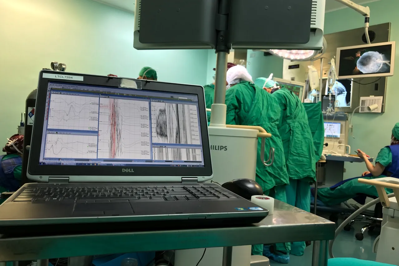 Spinal monitoring during surgery, with the surgical team behind