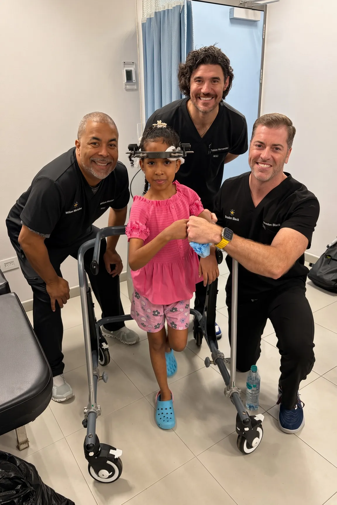 SpineHope surgeons with a young patient and her walker