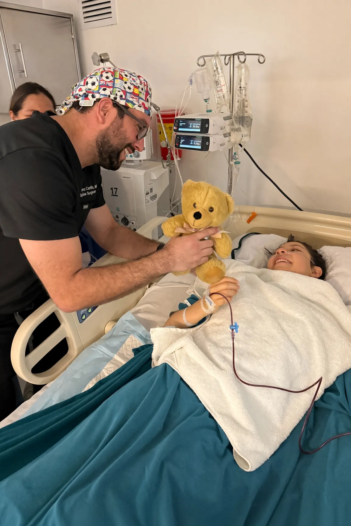 A SpineHope clinician at a young patient’s bedside